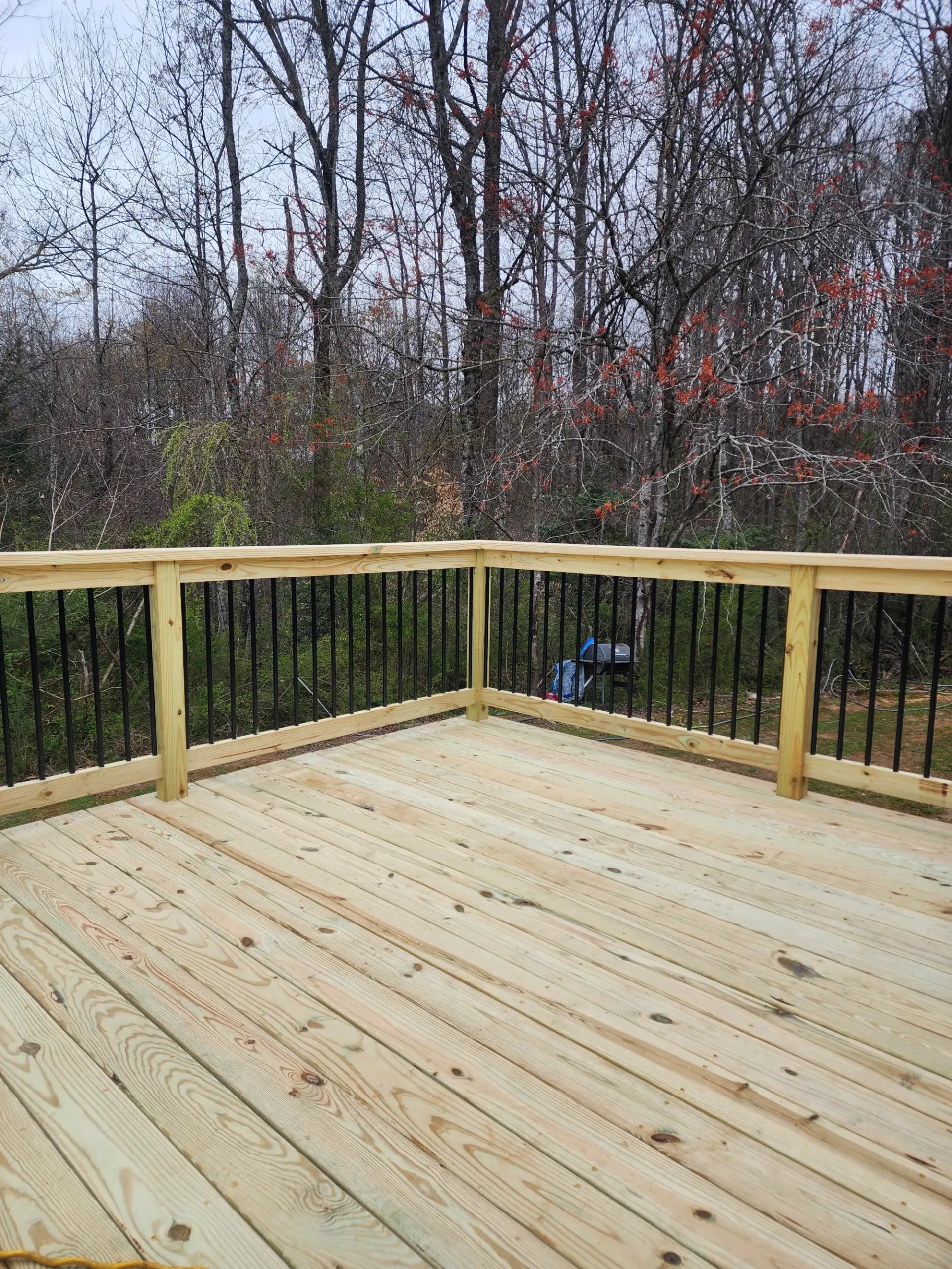 Completed deck with outdoor seating by Footer to Ridge Construction