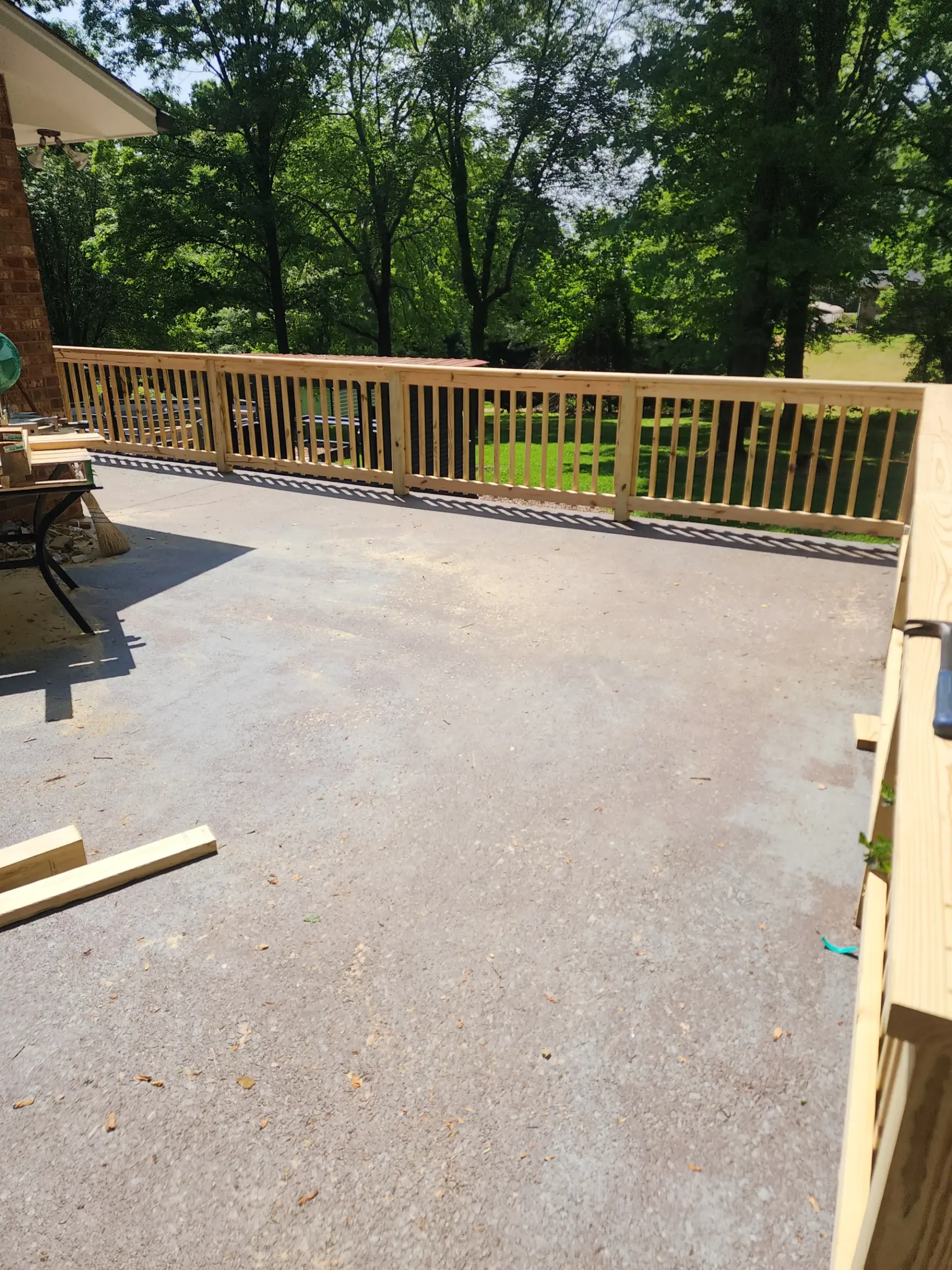 Finished open deck and railing by Footer to Ridge Construction