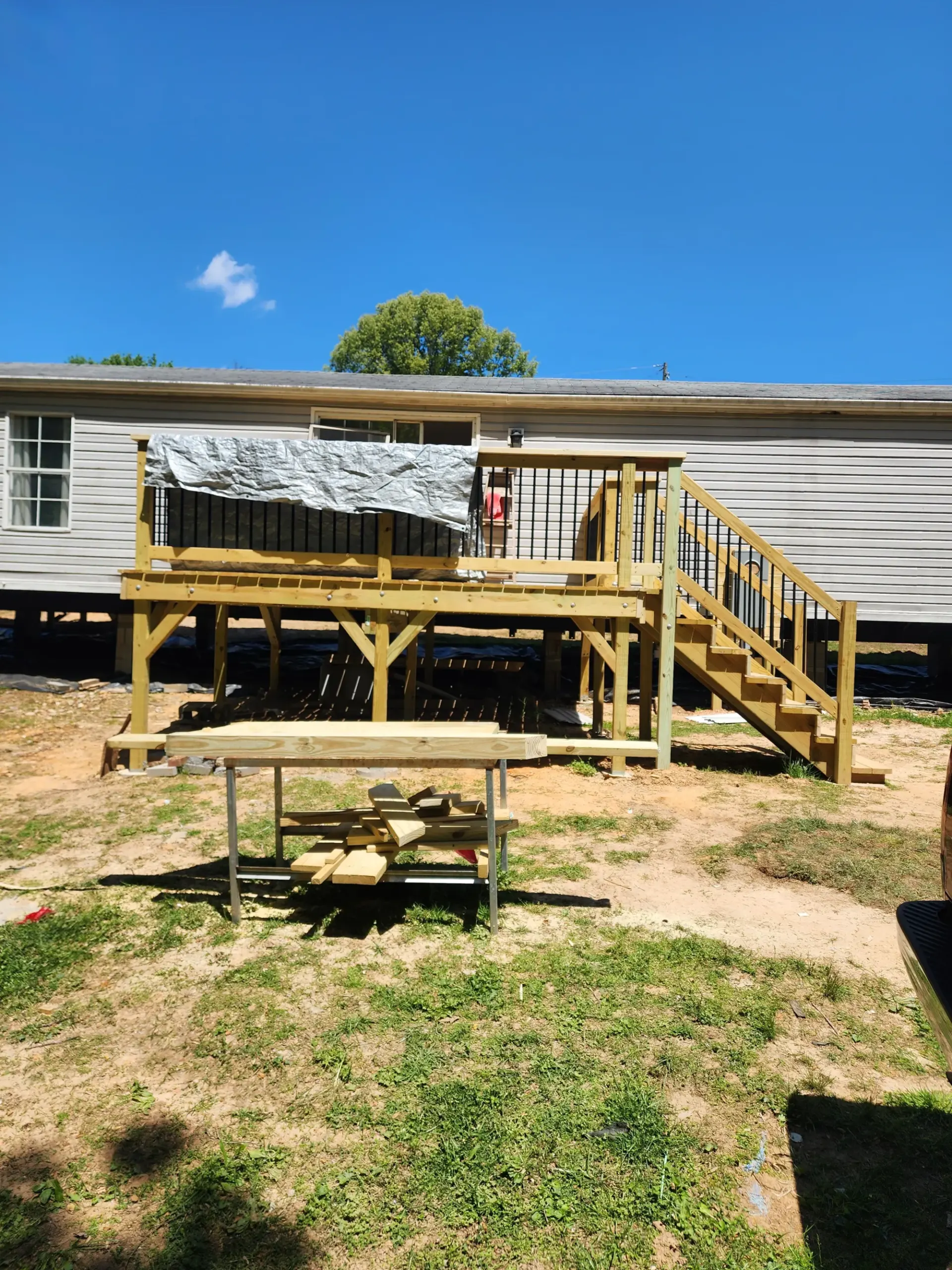 Finished wood deck railing by Footer to Ridge Construction