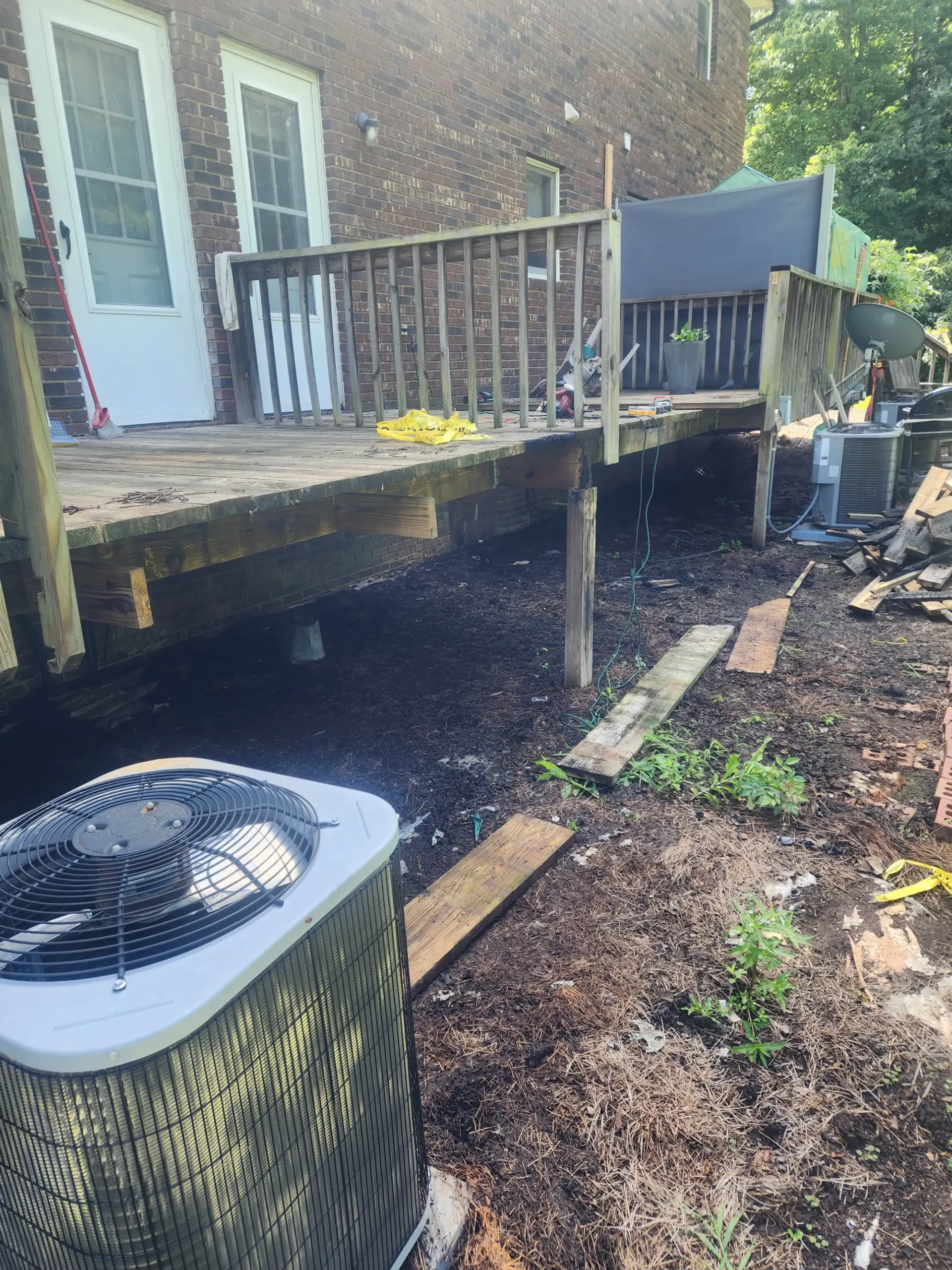 Finished raised deck with stairs by Footer to Ridge Construction